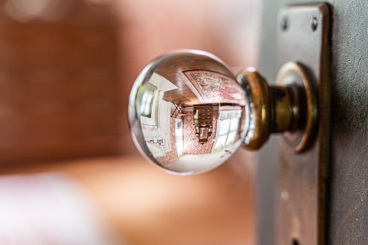 Antique glass doorknob with the room in the reflection