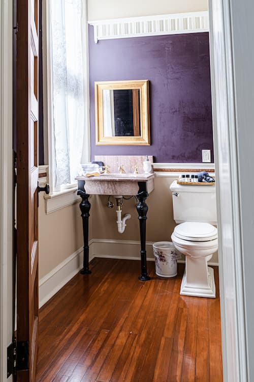 Bathroom entrance off of Letitia's bedroom; pedestal sink near west window