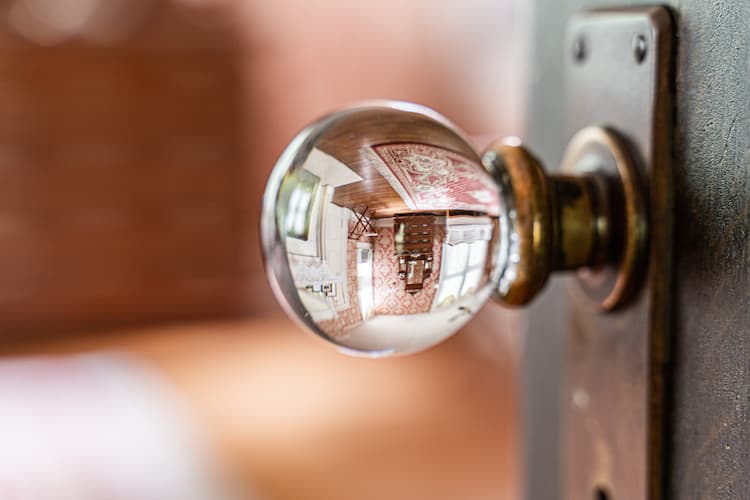 Antique glass doorknob with the room in the reflection