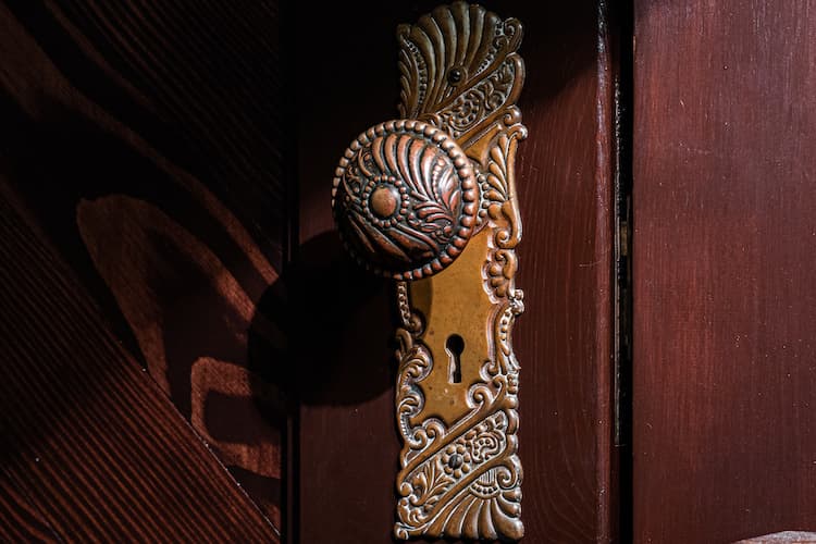 Close up of the antique door knob and lock with intricate detail