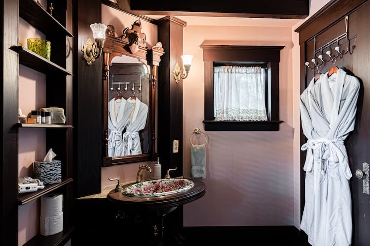 Private bathroom with bathrobes and amenities