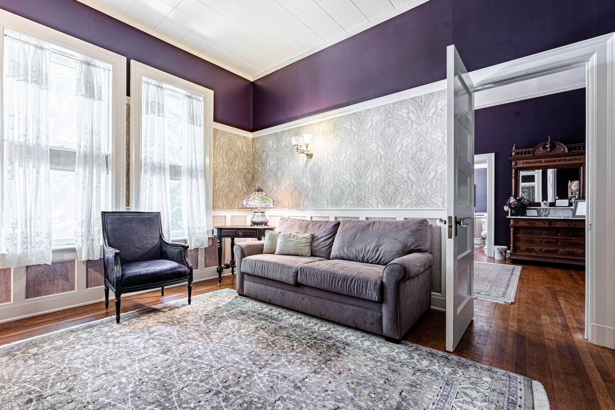 Letitia's private Sitting Room with West facing twin windows. Peacock stained glass screen, purple horse hair chair and dark bone cushion sofa.