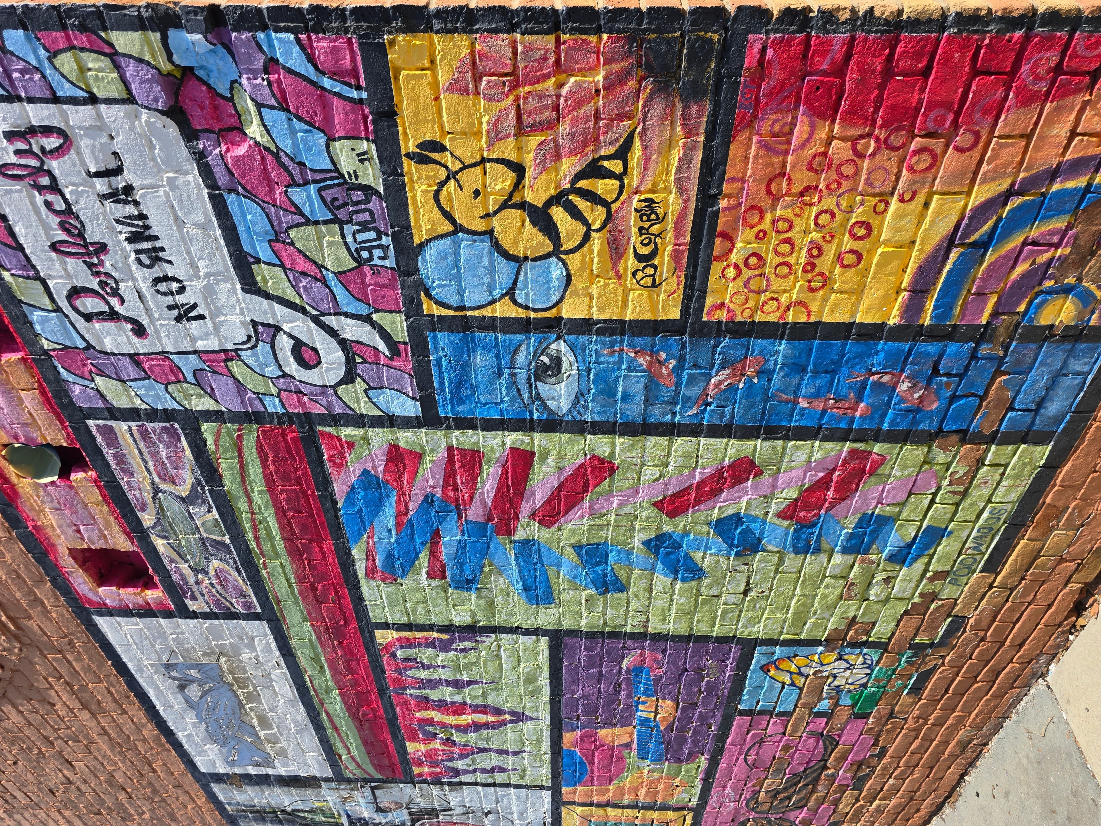 Colorful mural featuring a variety of abstract designs and patterns.