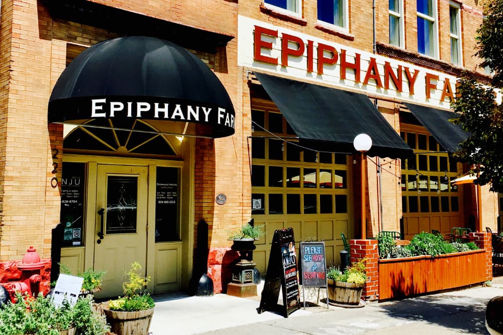 Exterior of Epiphany Farms featuring a black awning and welcoming entrance.