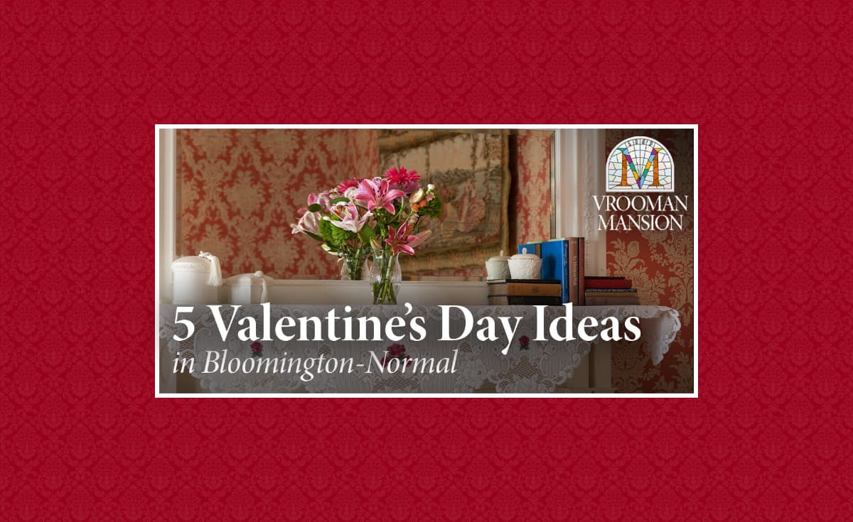 A well-decorated table with flowers and candles, highlighting Valentine's Day ideas at Vrooman Mansion in Bloomington-Normal.