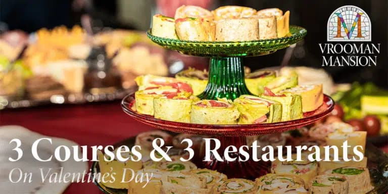 A display of layered rolls on decorative stands promoting a Valentine's Day dining event at Vrooman Mansion.