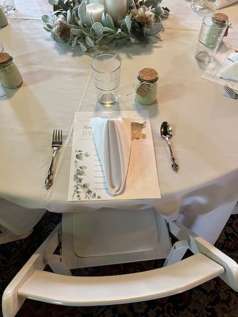 A beautifully set dining table featuring a menu, silverware, and a neatly folded napkin.