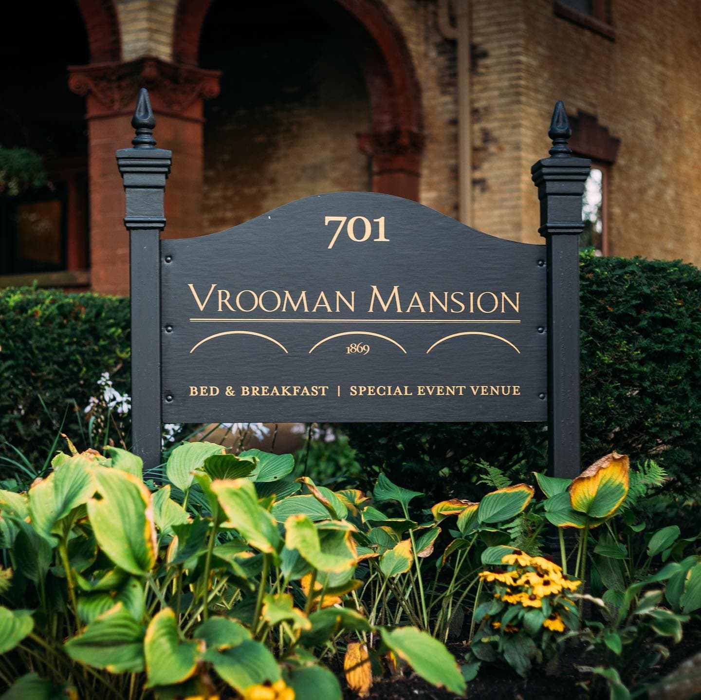 Sign for Vrooman Mansion, established in 1869, indicating it is a bed and breakfast and special event venue. Sign for Vrooman Mansion, established in 1869, indicating it is a bed and breakfast and special event venue.