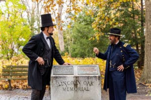 two actors portraying Abraham Lincoln and Ulysses S Grant in front of the Lincoln Oak Memorial