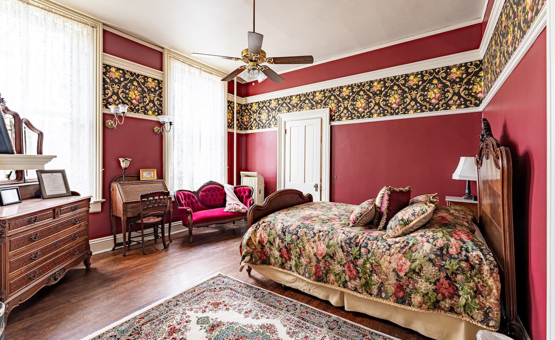 Rose Room with vibrant rose themed bedspread and wallpaper