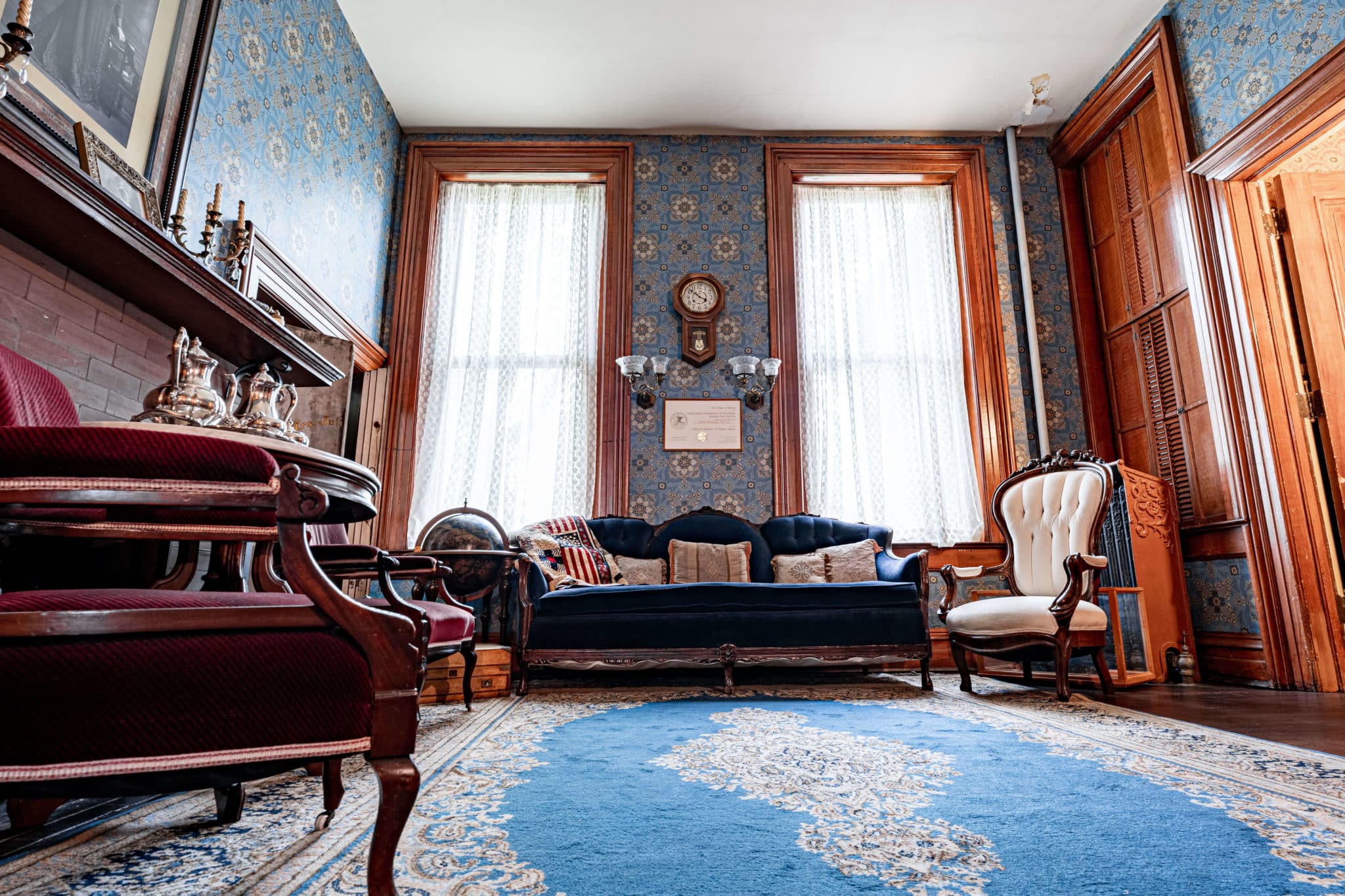wide angle view of the Safe Room with a vibrant blue rug and couch